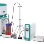 Front view of the Deluxe Perfusion Benchtop BPC system showing the gas and bioreactor modules, bioreactor vessel on an external scale, ATF unit, and tubing connections.