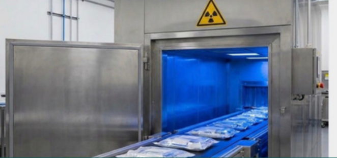 Consumables on a conveyor entering a gamma irradiation chamber